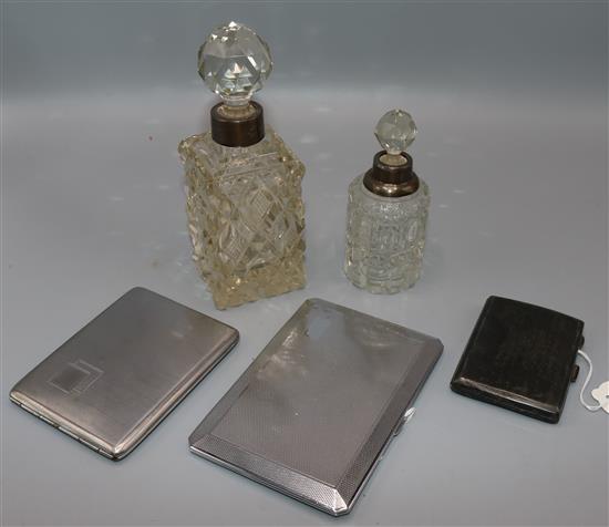 Two silver-mounted glass toilet bottles, a silver engine-turned cigarette case and two plated examples